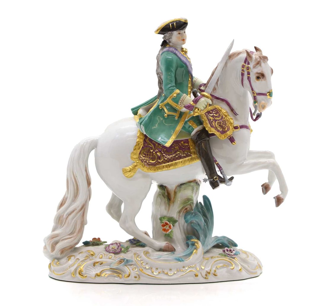 A Meissen group Czarina Elizabeth on horseback: A Meissen group Czarina Elizabeth on horseback 20th century, after Johann Joachim Kandler, wearing a green frock coat with sword in her hand on a rearing white horse, incised with crossed swords mark,