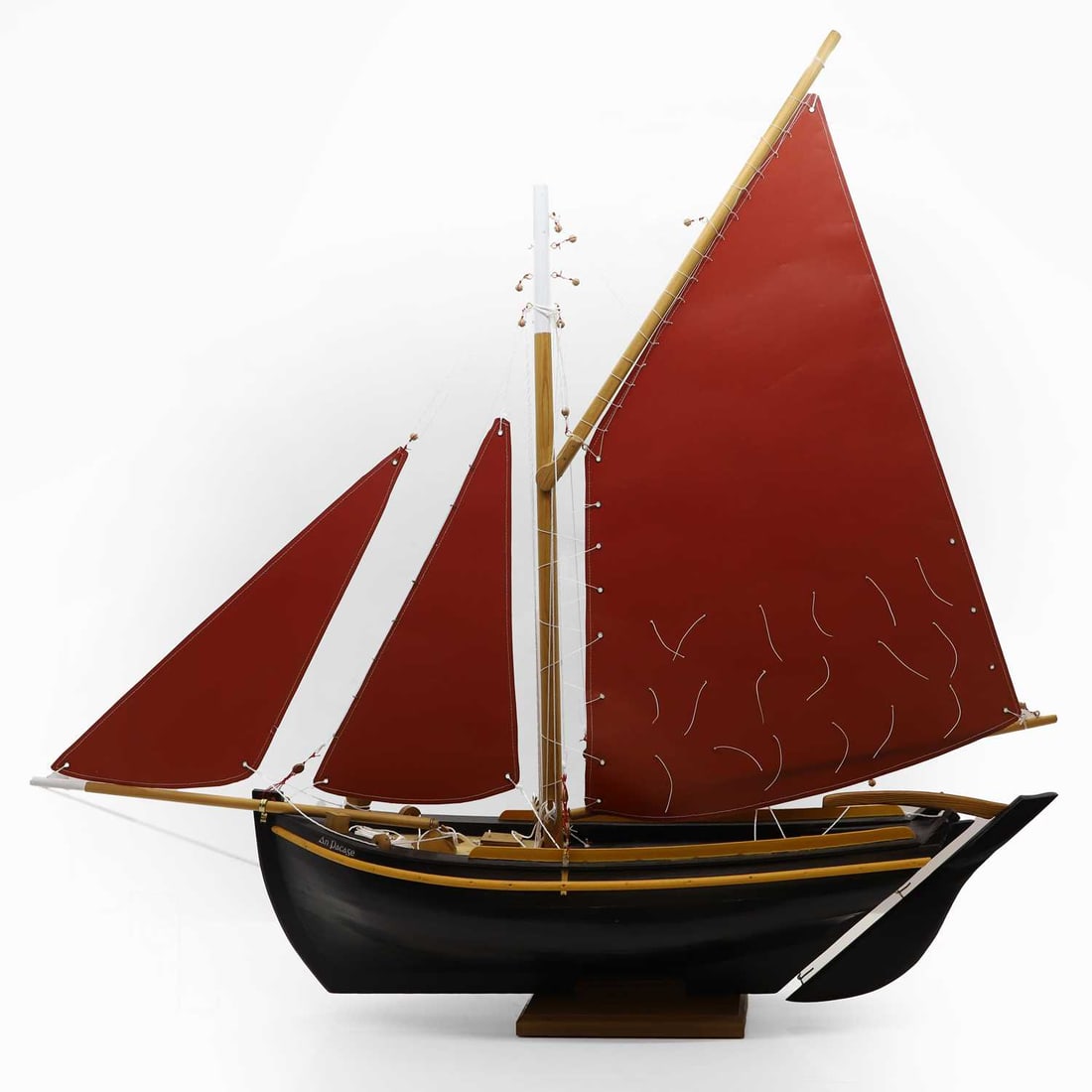A scratch-built Galway Hooker pond yacht,: A scratch-built Galway Hooker pond yacht, of recent manufacture, fitted with three red sails, named 'An Pacase', 110cm long 101cm high Condition Report: Appears to be in good order.