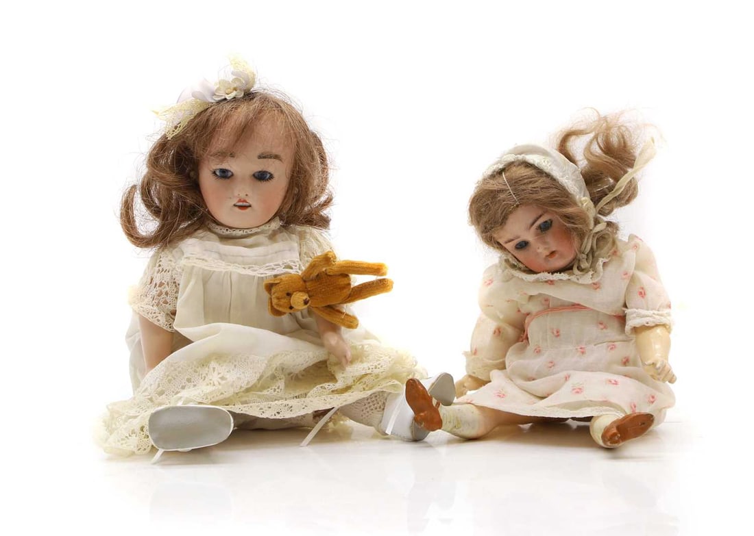 Two small bisque head dolls,: Two small bisque head dolls, a Simon and Halbig Kämmer & Reinhardt and Limoges marked, both with glass eyes and mouths open, both jointed bodies, 24cm and 22cm approx (2) Condition Report: Fair o