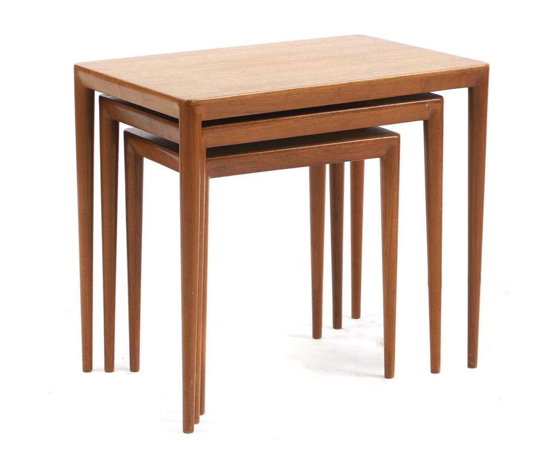 A nest of Danish teak tables,: A nest of Danish teak tables, c.1960, designed by Erik Riisager Hansen for Haslev Møbler, each with a chamfered top over turned support, labelled and stamped, largest 58cm wide 36.5cm deep 53cm h