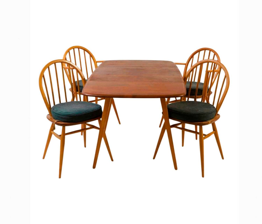 An Ercol elm and beech Windsor dining suite: An Ercol elm and beech Windsor dining suite c.1950, comprising a drop leaf table, two side chairs, and two elbow chairs, chairs labelled, table 65cm wide, 138cm extended 74.5cm deep 72cm high elbow ch