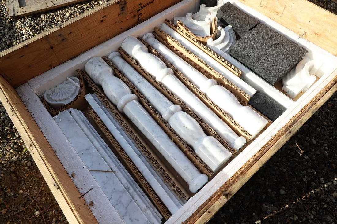 A Carrara marble frame and vanity set,: A Carrara marble frame and vanity set, 20th century, currently dismantled, with a frame, vanity top, and supports, no bowl, Condition Report: With one marble section broken. Corner section broken in t