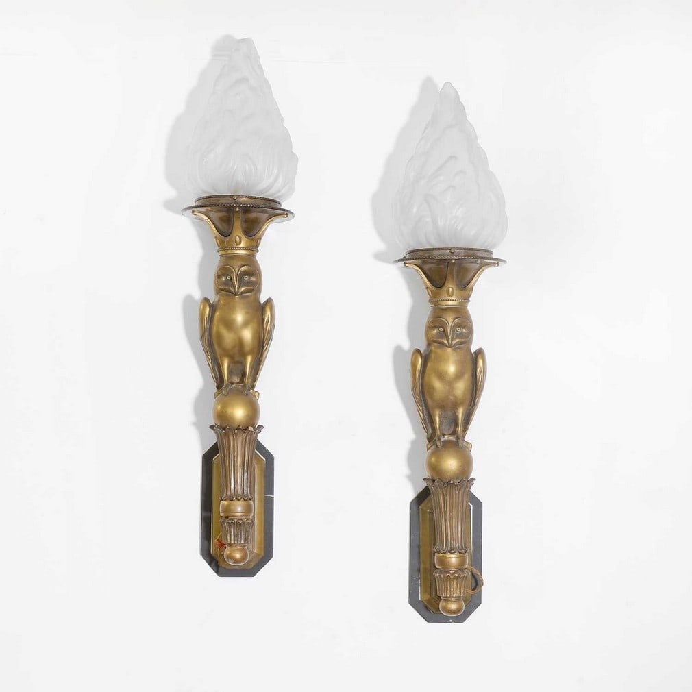 Art Deco,: Art Deco, a pair of patinated metal and giltwood wall lights, 1930s, each modelled as an owl with glass eyes, standing on a sphere, with giltwood mounts, a crowned sconce and mounted with a moulded gl