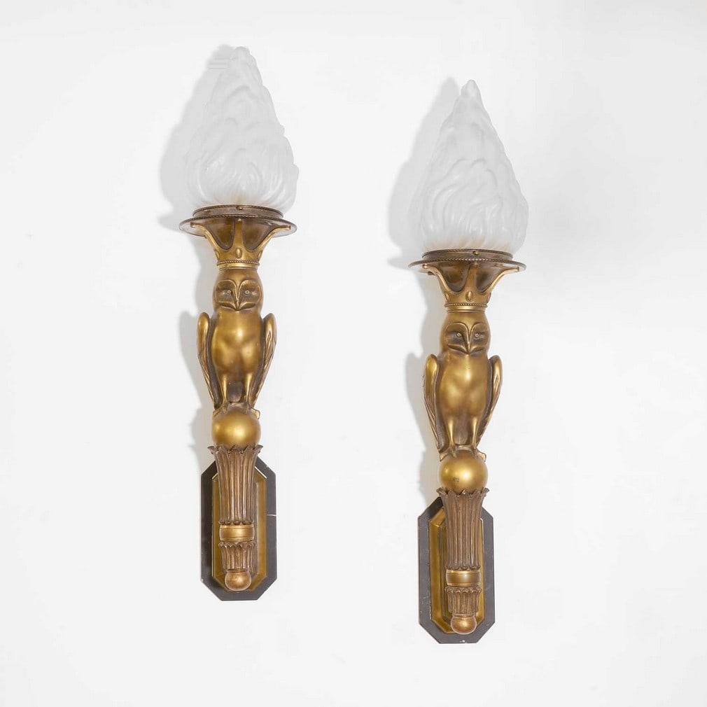 Art Deco,: Art Deco, a pair of patinated metal and giltwood wall lights, 1930s, each modelled as an owl with glass eyes, standing on a sphere, with giltwood mounts, a crowned sconce and mounted with a moulded gl