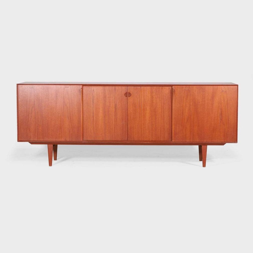 Henry Rosengren Hansen (Danish, 1899-1978) for Brande Møbelindustri,: Henry Rosengren Hansen (Danish, 1899-1978) for Brande Møbelindustri, a teak sideboard, c.1960, with four sliding doors, concealing a central arrangement of drawers flanked by shelves, labelled 'd