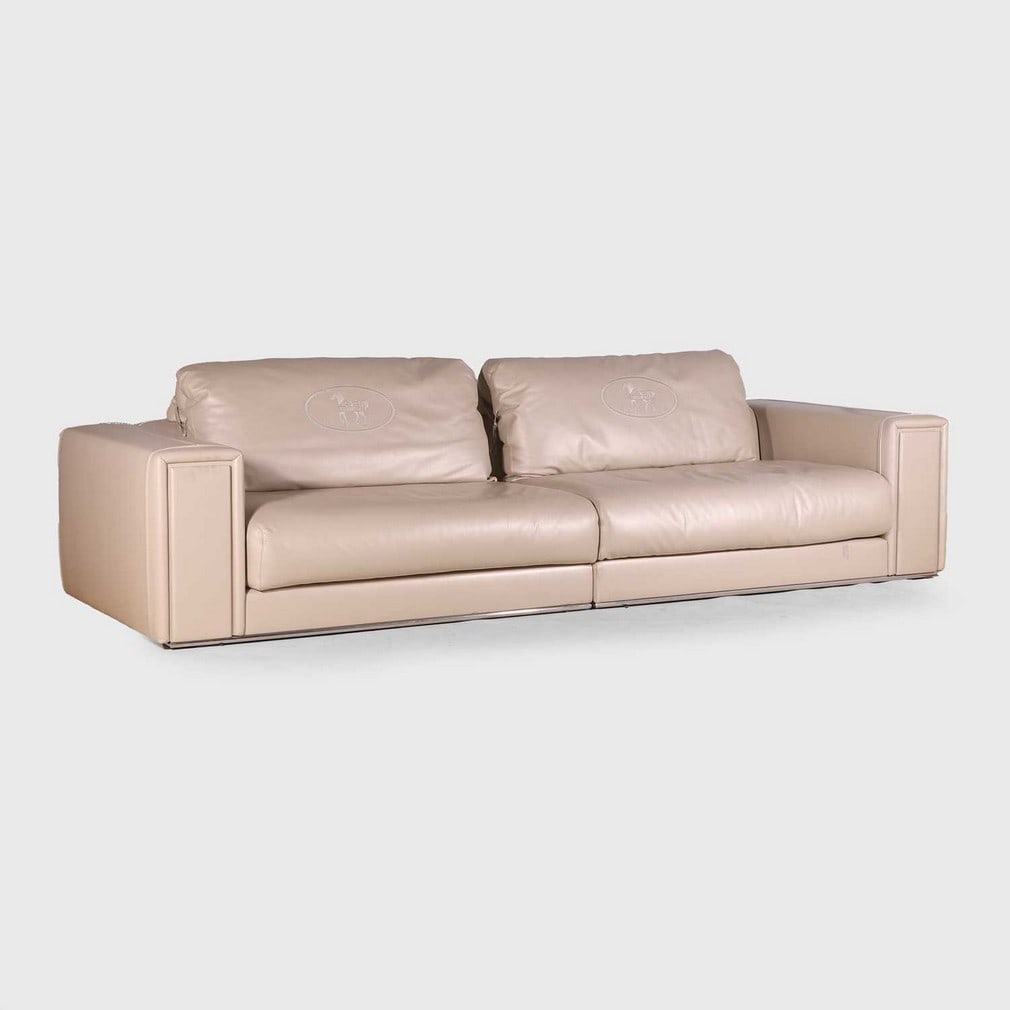 Fendi,: Fendi, a grey leather sofa, with two back cushions embroidered 'Fendi' with horse motif, raised on a polished aluminium frame, with metal plaque inscribed 'Fendi', 293cm wide 105cm deep 80cm high, sea