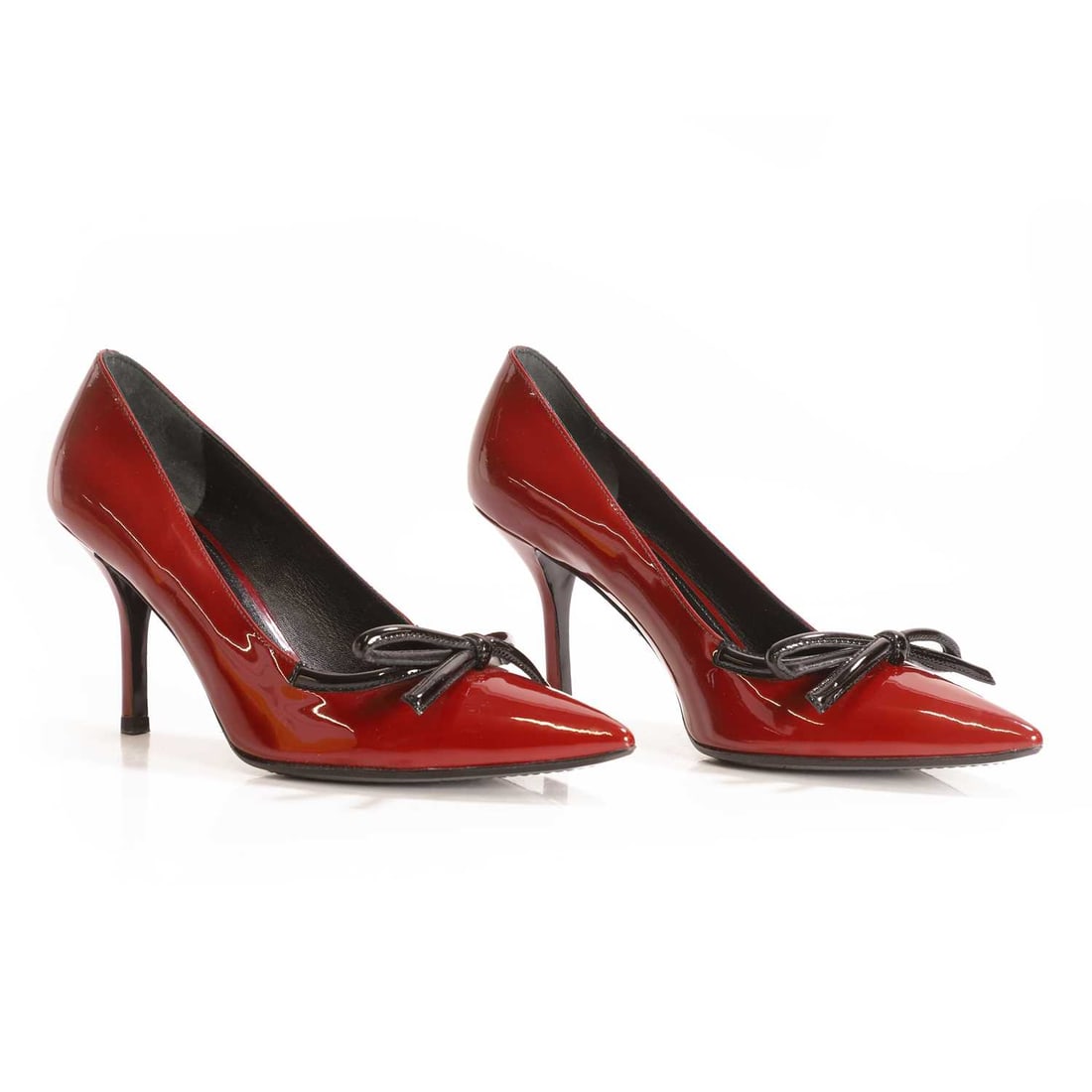 A pair of Prada patent leather heels,: A pair of Prada patent leather heels, of recent manufacture, in burgundy patent leather, with pointed toe and black bow detail, with box, dustbag and replacement heel tips, size EU 40, 9cm heel height
