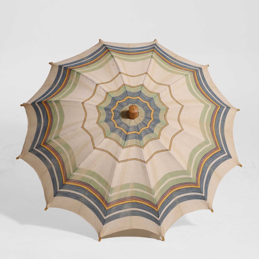 A Hermes parasol: A Hermes parasol 20th century, the canvas with green, blue, yellow, purple and pink stripes, the tube and runner stamped 'HERMES Paris', with bamboo handle, 52cm long Condition Report: Good overall co