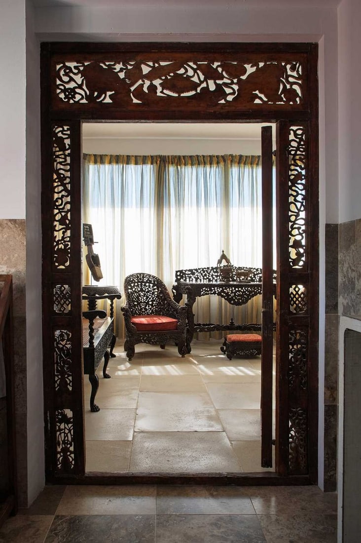 A hardwood console table,: A hardwood console table, c.1860-70, Anglo-Indian, with a pierced scrolling and foliate back, centred with a roundel with a bird issuing a flower, with a serpentine front raised on lion-mask-mounted a