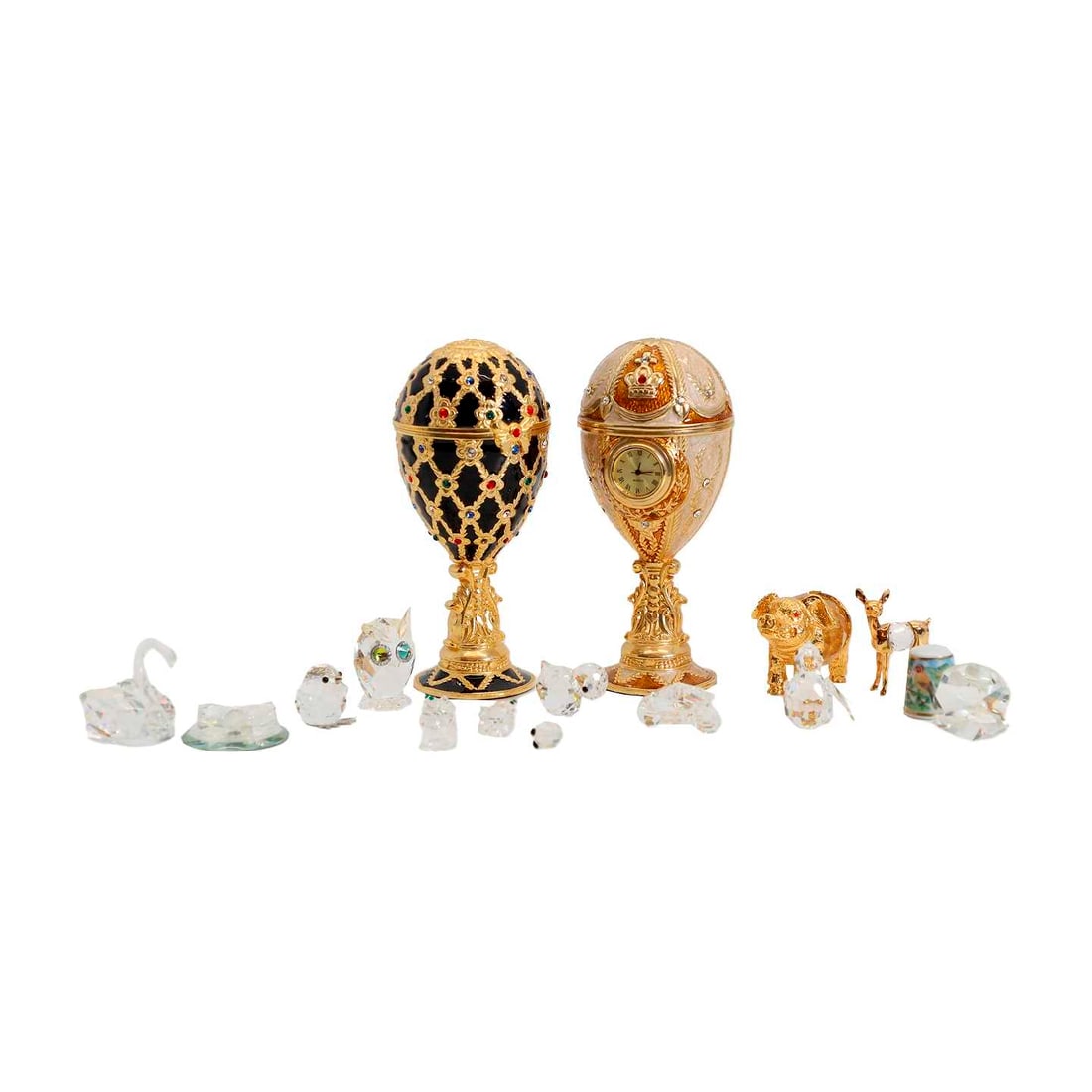 Two Faberge-style eggs: Two Faberge-style eggs modern, each fitting with a musical mechanism, one fitted with a quartz clock, 13.5cm high, a Jay Strongwater bottle stopper, 11cm, four enamelled and porcelain pill boxes, 5.5c