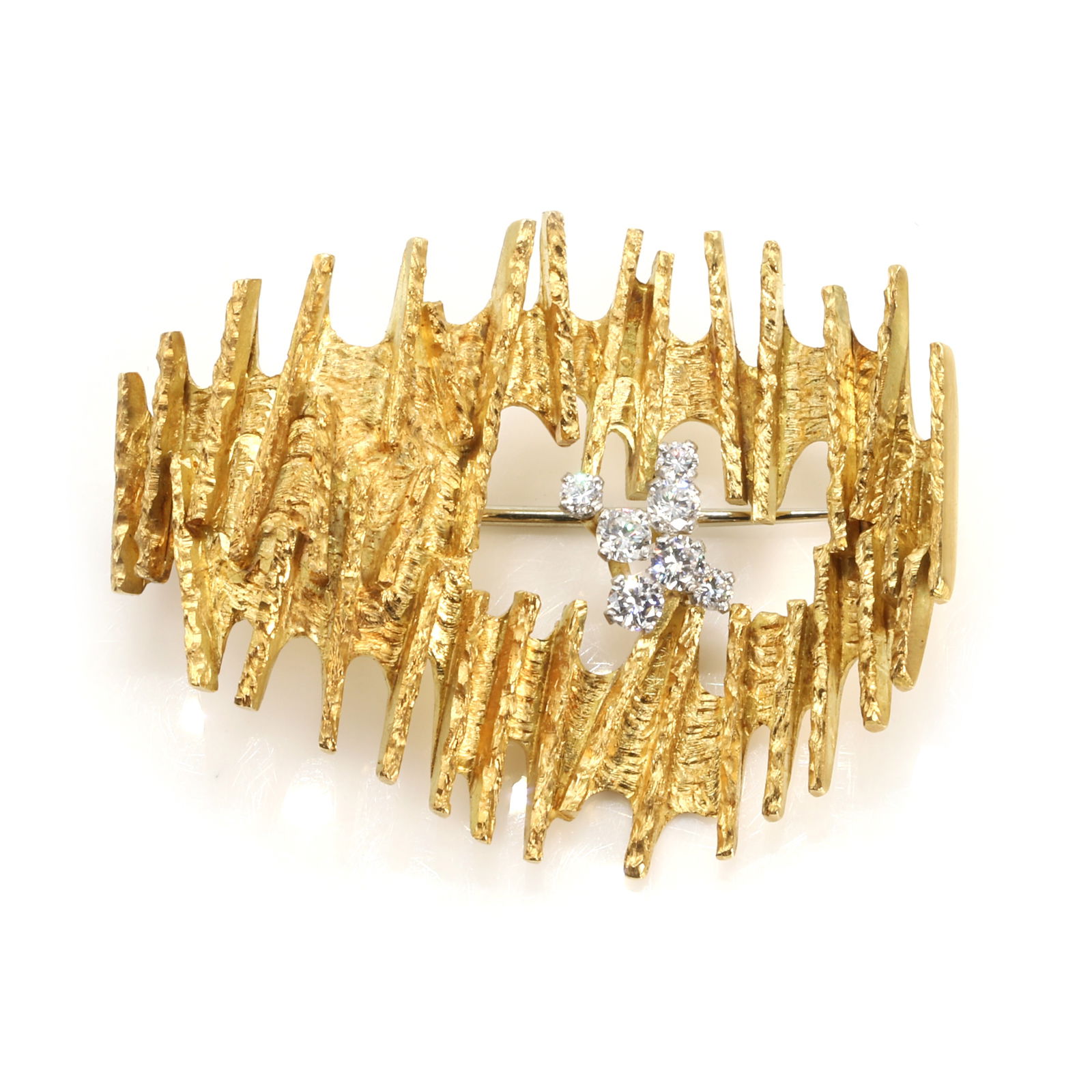 An 18ct gold diamond set brooch, by Andrew Grima,: An 18ct gold diamond set brooch, by Andrew Grima, of abstract asymmetrical form, the textured plaque with central opening enclosing a cluster of round brilliant diamonds in claw setting. Maker's mark