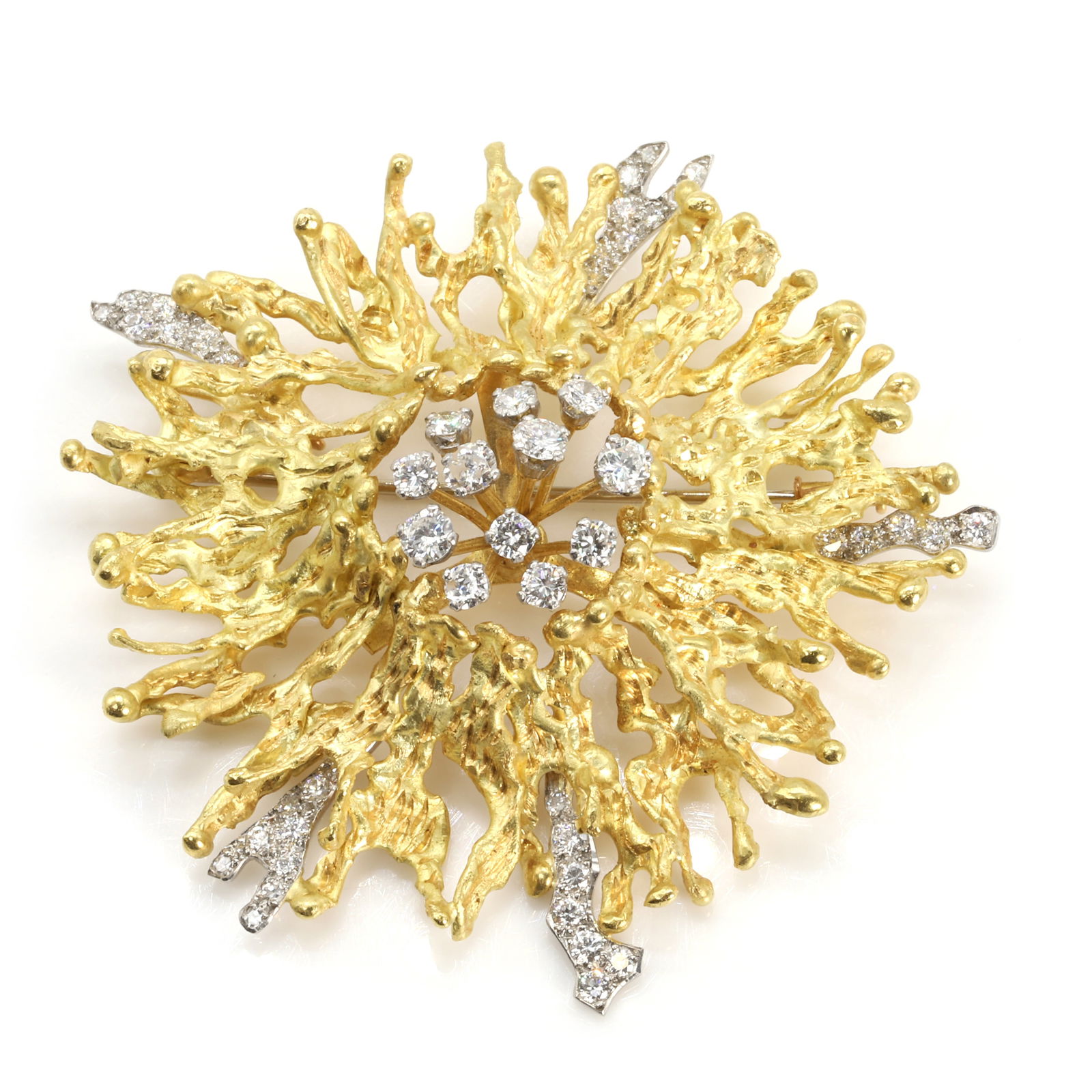 An 18ct gold diamond set brooch, by Andrew Grima,: An 18ct gold diamond set brooch, by Andrew Grima, of organic abstract design, centrally featuring a round brilliant diamond spray, to a radiating textured formation with round brilliant diamond accent