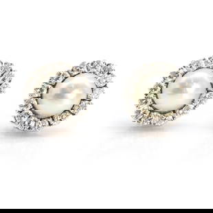 A pair of 14ct white gold cultured pearl and diamond stud earrings,: A pair of 14ct white gold cultured pearl and diamond stud earrings, of floral cluster design, each centred with an 8.00mm circular pearl, untested, within a surround of round brilliant cut diamonds, c