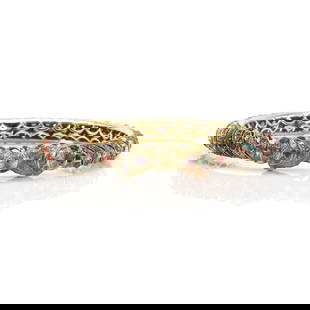 An Indian multi-gemstone hinged bangle,: An Indian multi-gemstone hinged bangle, the hinged bangle set with alternating vari-coloured gemstones, to include ruby, pearl, emerald, coral and sapphire, in a turban pattern to a double elephant he