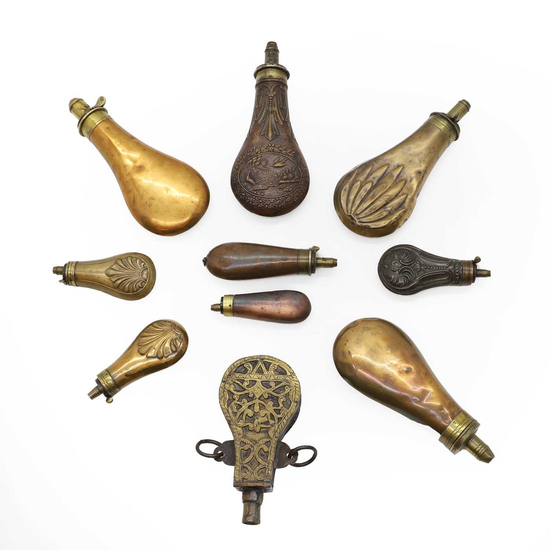 A collection of leather powder flasks: A collection of leather powder flasks one having embossed decoration and brass mount, 20cm long Condition Report: some broken, others with dents, marks, scratches and scuffs