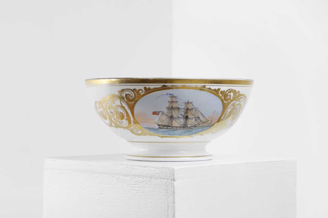 An 'Elsinore' porcelain ship's portrait bowl,: An 'Elsinore' porcelain ship's portrait bowl, mid-19th century, Danish, painted in colours with an oval cartouche depicting a ship under full sail flying the British flag, with Kronborg Castle in the
