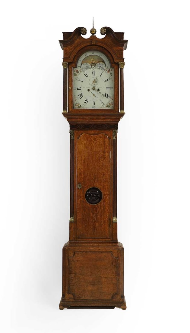 A George III oak longcase clock,: A George III oak longcase clock, by George Goodall, Tadcaster, the broken arch dial with ship phase, over a shaped trunk door, complete with a pendulum, 230cm high Condition Report: Knocks, wear, and