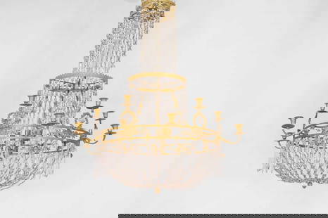 A neoclassical ormolu and cut-glass chandelier,: A neoclassical ormolu and cut-glass chandelier, late 18th century and later, Northern European, with twelve sconces and numerous variously shaped drops, decorated all over with foliate motifs, with a