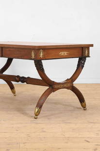 A Regency mahogany writing table in the manner of John McLean,: A Regency mahogany writing table in the manner of John McLean, early 19th century, the rectangular top with a green leather surface with gilt-tooled Greek key decoration, above a frieze set with pair