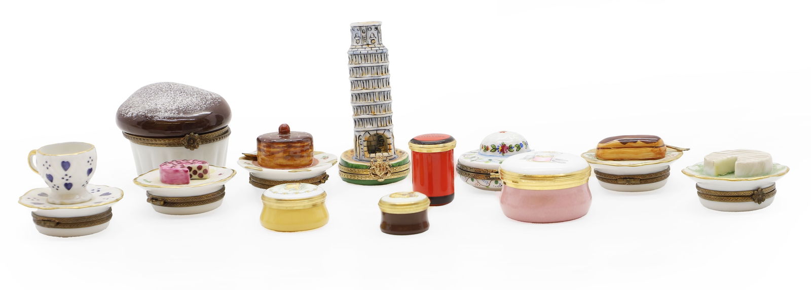 A Limoges Peint Main pill box,: A Limoges Peint Main pill box, with teacup surmount, 5cm diameter, together with six further examples, each decorated with cake surmount, four enamel pill boxes, and a novelty box with leaning tower o
