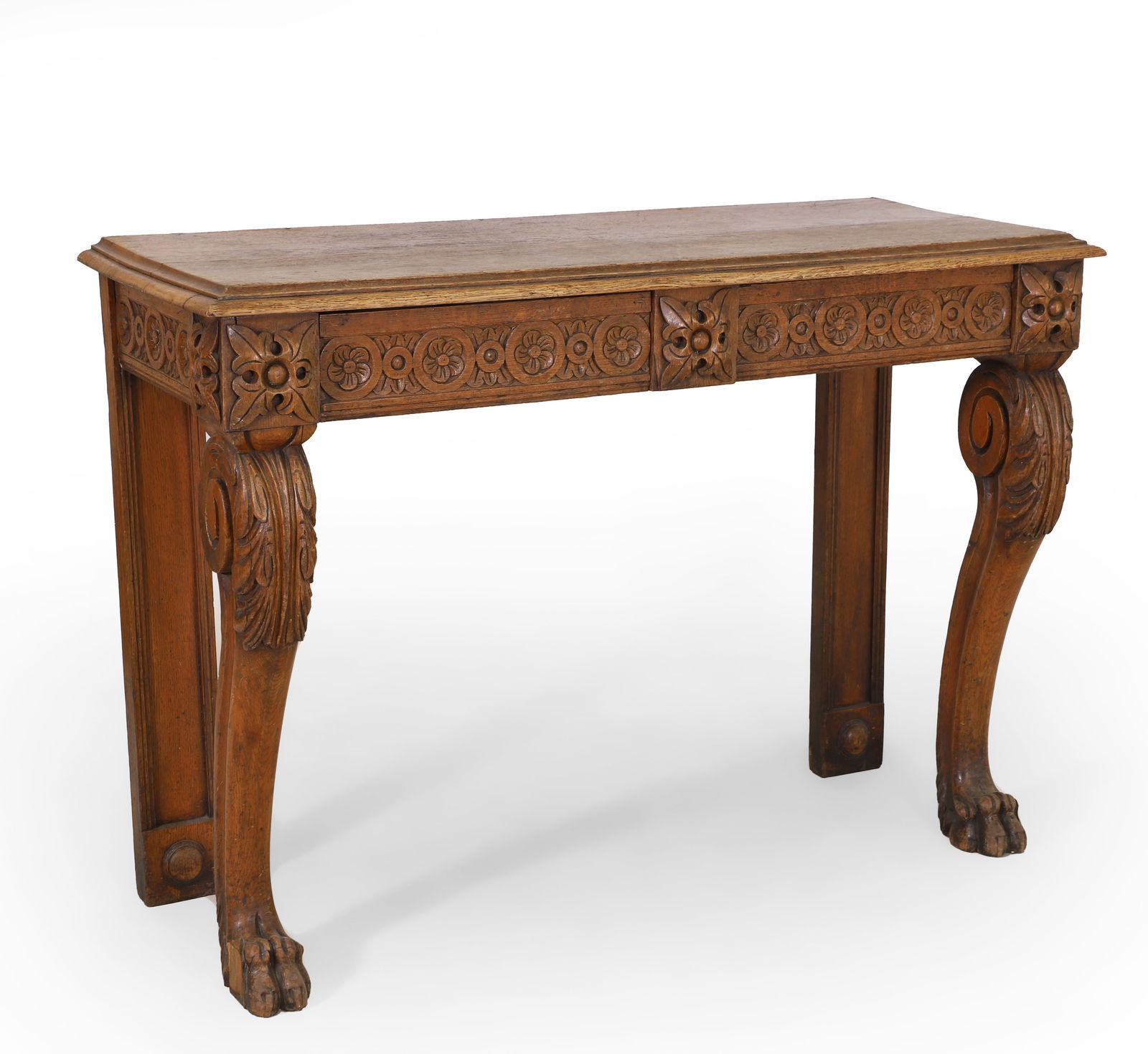 An oak console table: An oak console table with a moulded top, over a carved frieze with two drawers, on scrolled front supports, 122cm wide 48cm deep 86cm high Condition Report: Used and with wear.