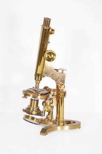 A brass binocular microscope,: A brass binocular microscope, late 19th to early 20th century, raised on an integral brass plinth, stamped 'Ross 5180 London', 57.5cm high