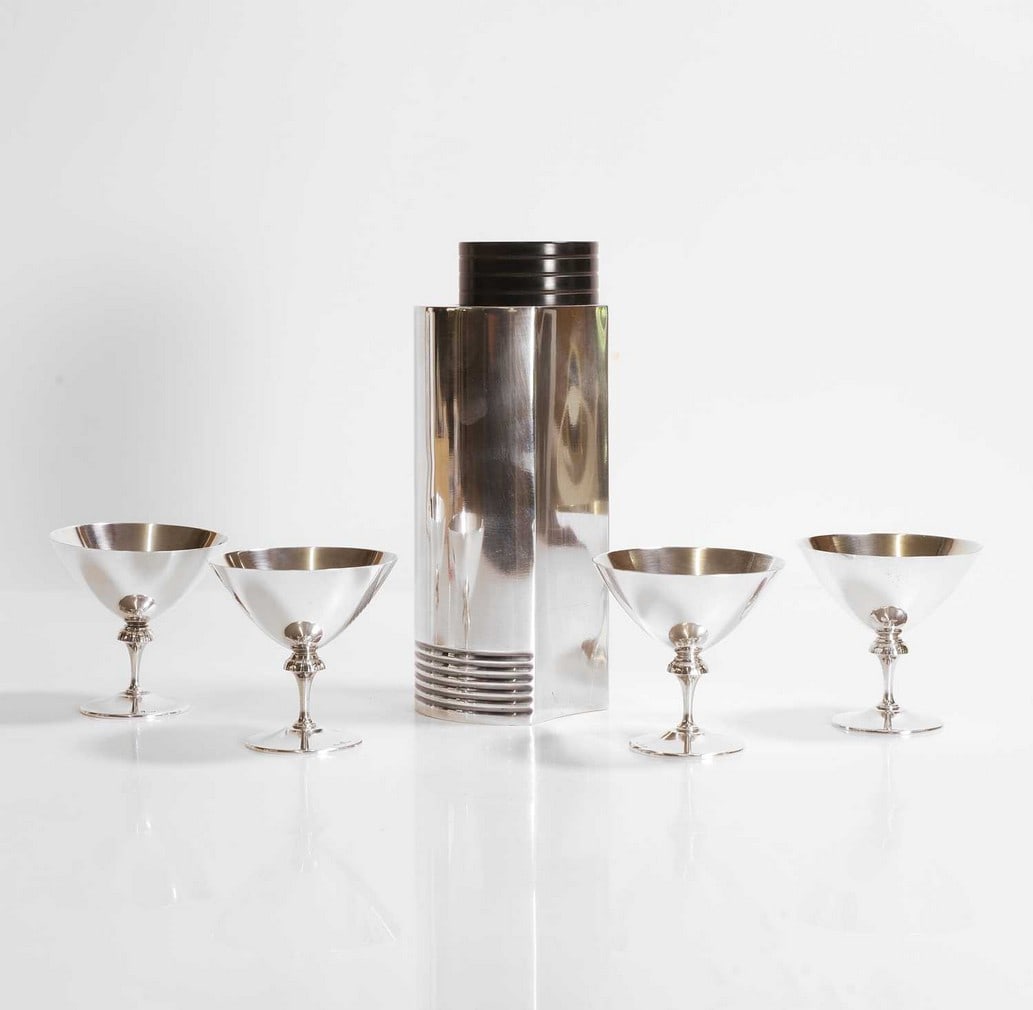 Folke Arström (Swedish, 1907-1997) for GAB,: Folke Arström (Swedish, 1907-1997) for GAB, an Art Deco silver-plated cocktail shaker and cocktail glasses, 1930s, with a shaped body with a Bakelite screw-on cover, the shaker with remnants of m
