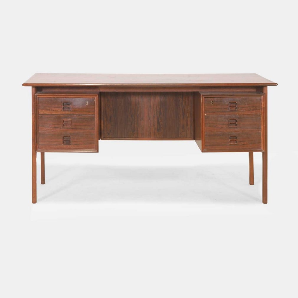§ Arne Vodder (Danish, 1926-2009),: § Arne Vodder (Danish, 1926-2009), a rosewood desk, with an arrangement of drawers either side of a well, with shelves to the back, 145cm wide 75cm deep 72cm high Article 10 Transaction Specific