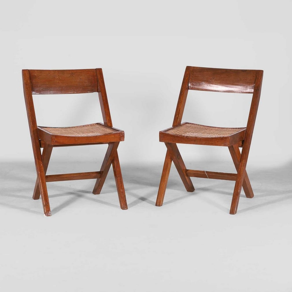 Pierre Jeanneret (Swiss, 1896-1967),: Pierre Jeanneret (Swiss, 1896-1967), a pair of 'PJEC-010301 Library Chairs’ or ‘Chaise En Teck’, designed for Chandigarh, c.1959-60, each of teak and cane, with a brown upholstered s