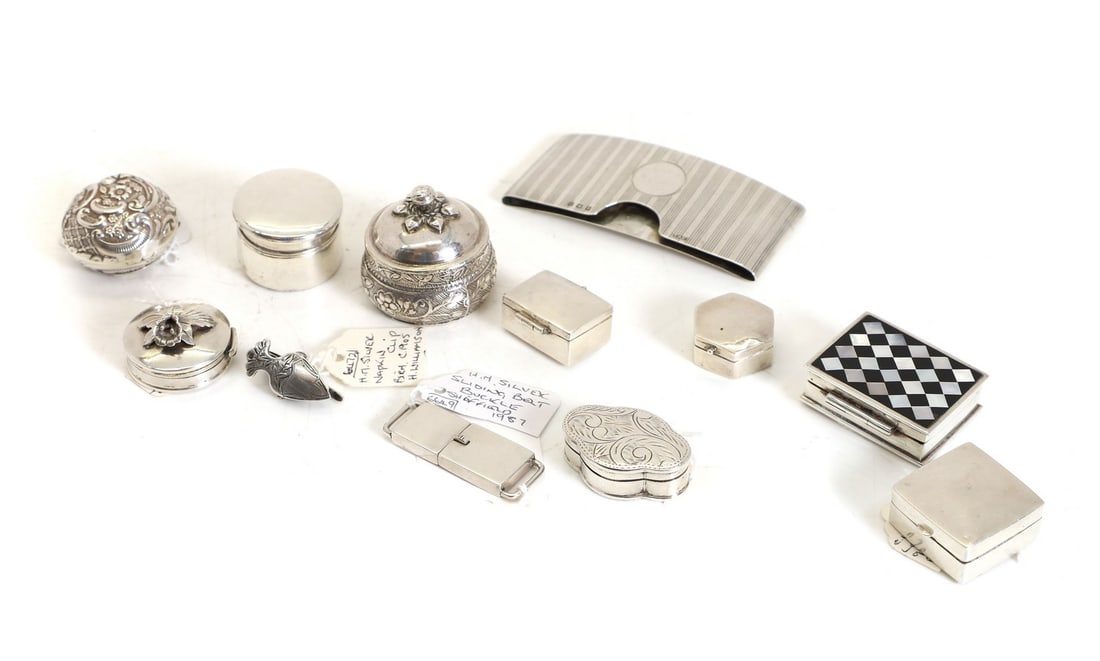 An Edwardian silver pill box,: An Edwardian silver pill box, by Thomas Hayes, Birmingham 1901, of plain cylindrical form, 2cm high, together with eight other similar, a silver card case, Birmingham 1911, 8.3cm wide, a silver napkin