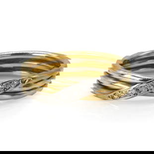An 18ct two colour gold diamond crossover ring,: An 18ct two colour gold diamond crossover ring, with a crossover line of round brilliant cut diamond and eight cut diamonds, all grain set in white, to a yellow three row wire shank, London 1989, 4.58