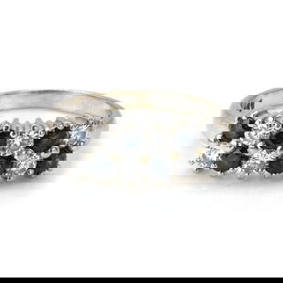 An 18ct white gold sapphire and diamond cluster ring,: An 18ct white gold sapphire and diamond cluster ring, with two rows of alternating round cut sapphires and round brilliant cut diamonds, all claw set into tapered shoulders and a 'D' profile shank, Lo