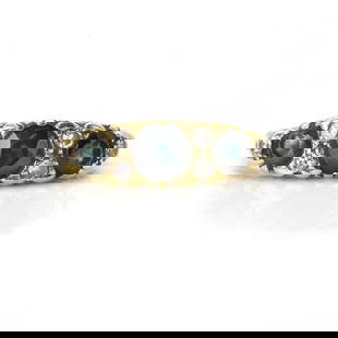 A sapphire and diamond three stone ring,: A sapphire and diamond three stone ring, three graduated round cut sapphires, spaced with round brilliant cut diamonds, set to scroll gallery sides, mounted in yellow gold stamped 18ct, 5.02g Ring siz