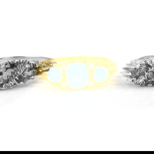 An 18ct gold sapphire and diamond ring,: An 18ct gold sapphire and diamond ring, claw set with a central oval cut sapphire, flanked by grain set eight cut diamonds and a round cut sapphire to either side, to an incised scrollwork mount and s