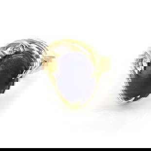 A lapis lazuli and diamond ring,: A lapis lazuli and diamond ring, with an oval lapis lazuli cabochon, claw set to an open curved mount with a round brilliant cut diamond claw set in white to one side, into a flat section band, stampe