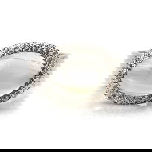 A silver moonstone ring,: A silver moonstone ring, with an oval moonstone cabochon, 14mm x 10mm, bezel set to a textured surround, into a wide flat court profile shank, London 2023, 12.24g Ring size L?&#189; Buying this gemsto