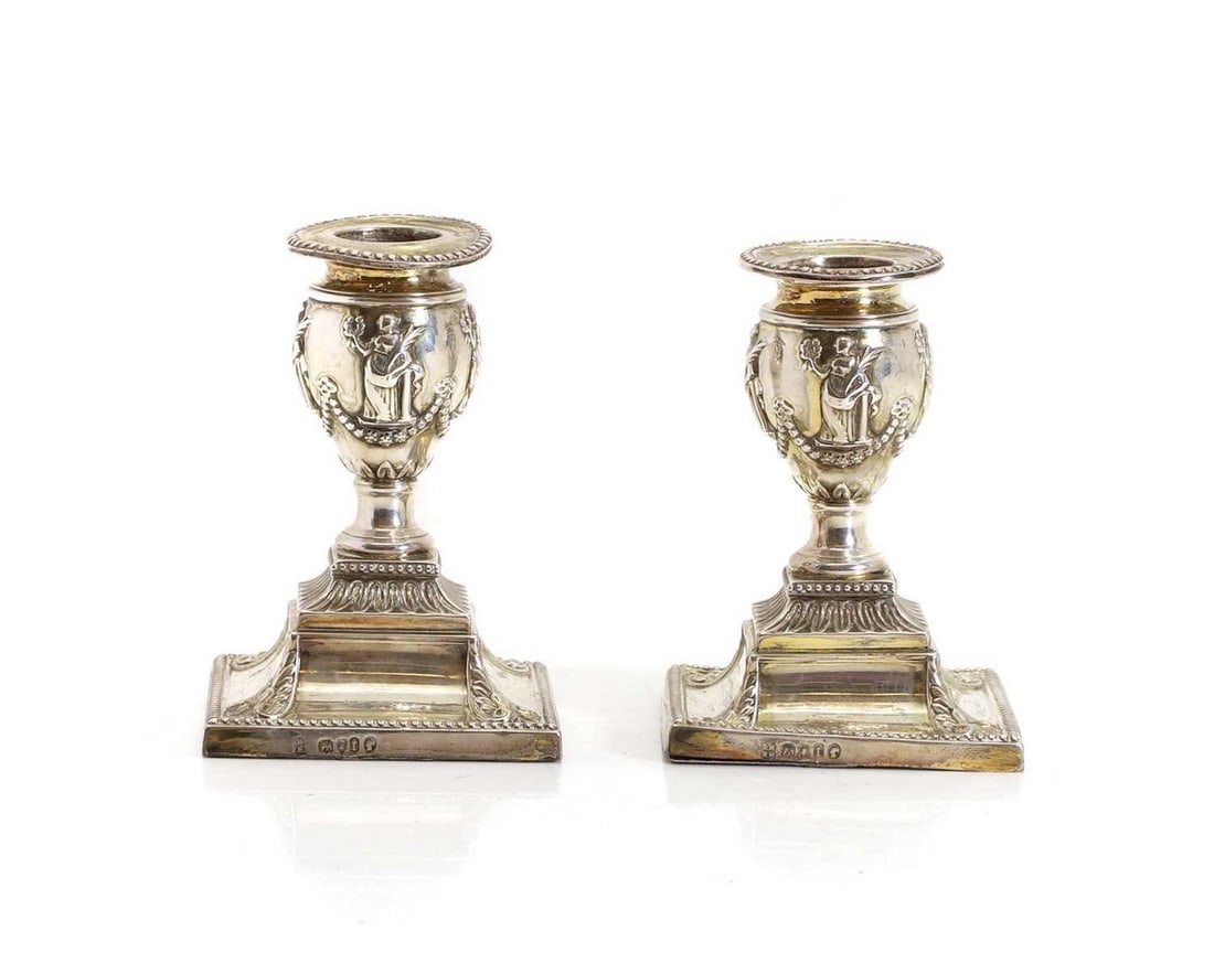 A pair of Edwardian silver candlesticks: A pair of Edwardian silver candlesticks 20th century, By Richard Hodd & Son, London 1914, 11cm tall
