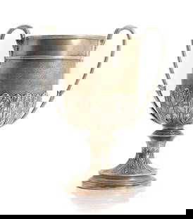 A silver twin handled trophy cup,: A silver twin handled trophy cup, markers mark indistinguishable, Chester 1913, engraved 'Barnet Xmas Fat Stock Show Cup', 16.5cm high 19.7ozt Condition Report: Marks rubbed. Surface scratches, scuffs
