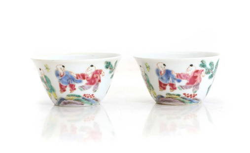 A pair of Chinese famille rose teacups,: A pair of Chinese famille rose teacups, 20th century, of circular form with a flared rim, painted with boys at play in a garden, 8cm diameter (2) Condition Report: Surface scratches.