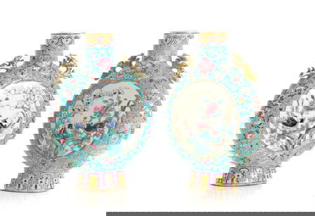 A pair of Chinese famille rose moon flasks,: A pair of Chinese famille rose moon flasks, 20th century, the compressed circular body decorated with pheasants among blossoming flowers or figures, flanked by dragon handles to the shoulder, 25cm hig