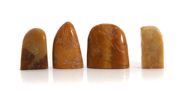 A group of four Chinese soapstone seals,: A group of four Chinese soapstone seals, 20th century, of various form, carved in a honey-coloured stone with literati in landscape scenes, 6 to 7cm high (4) Provenance: From the collection of the lat