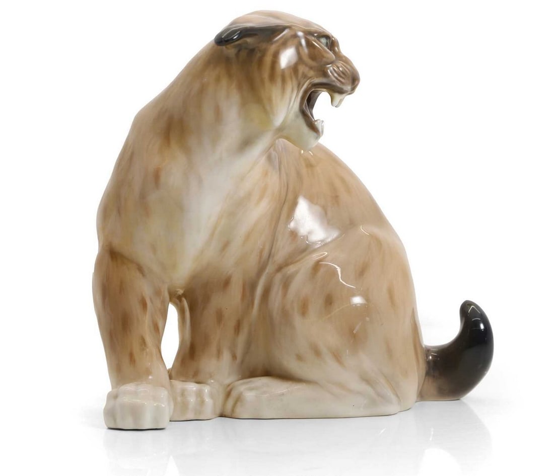 A Royal Copenhagen porcelain model of a lynx,: A Royal Copenhagen porcelain model of a lynx, 20th century, modelled by Knud Kyhn, modelled with its mouth open, painted marks, 29.5cm high Condition Report: Very small chip to the glaze of the of the