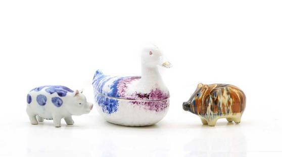 A group of three pottery animals,: A group of three pottery animals, comprising a Russian porcelain box and cover in the form of a duck, 20th century, a late Victorian slipware piggy bank and a Chinese blue and white pig, 20th century,