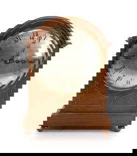 An Edwardian inlaid mahogany mantle clock,: An Edwardian inlaid mahogany mantle clock, the arched case, with a silvered convex dial with enamelled Roman numerals, with a twin fusee movement, striking the half hours on a gong, with a repeater on