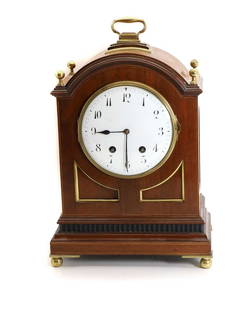 An Edwardian mahogany and brass mounted mantle clock,: An Edwardian mahogany and brass mounted mantle clock, with an enamelled convex dial, with Arabic numerals, enclosing a French twin fusee movement, striking on the half-hours on a gong, with pierced br