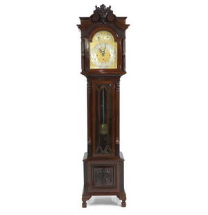 An Edwardian mahogany eight-day chiming longcase clock,: An Edwardian mahogany eight-day chiming longcase clock, the carved and pierced hood with a gilt and silvered dial, with three subsidiary dials, over a glazed trunk door with blind fret carved columns,
