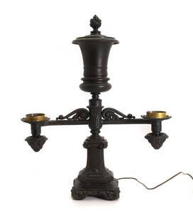 A bronze double branch Argand lamp,: A bronze double branch Argand lamp, 19th century, with a large central urn finial, the main support adorned with scrolls and acanthus leaves, on scrolled square base, plaque to one arm inscribed 'CLAR