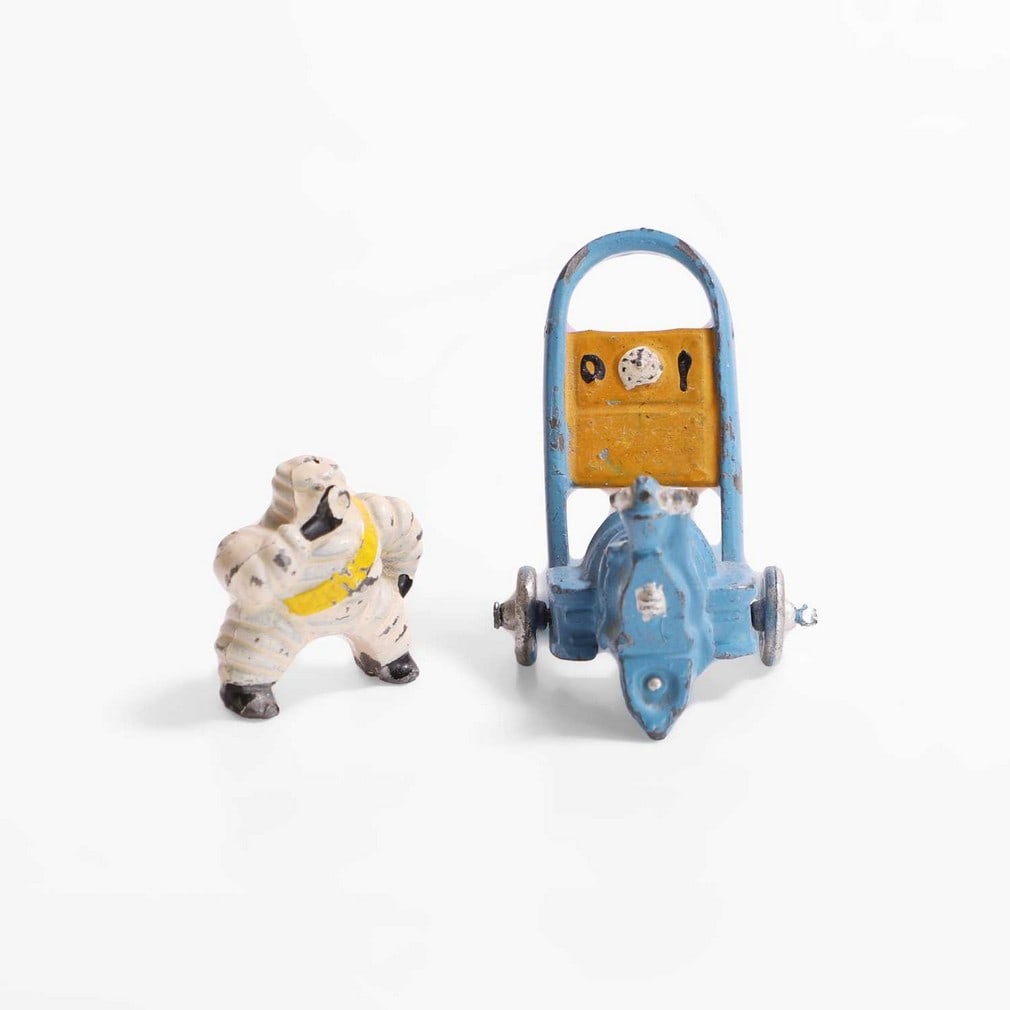 A miniature lead Michelin Man,: A miniature lead Michelin Man, c.1930, French, a rare lead and hand-painted figure sitting on a forecourt compressor, 4.5cm high (2) Condition Report: original paint work, some chips to paint otherwis