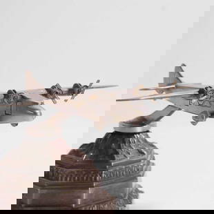 A RAF or Civil Aviation transport aeroplane model,: A RAF or Civil Aviation transport aeroplane model, c.1930, a presentation display model or car mascot representing a four-engined high-wing monoplane, with rotating propellers to engine nacelles, embe