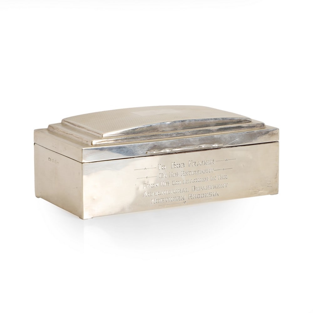 A silver cigarette box,: A silver cigarette box, by William Adams Ltd, 1948, Birmingham, inscribed to the front and with a wood-lined interior, 17.1cm wide 9cm deep 7cm high